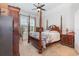Traditional bedroom featuring a four-poster bed, a ceiling fan, and ample natural light at 909 Witherbee Way, Little River, SC 29566