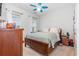 Bright bedroom with a ceiling fan, windows, and a wood dresser at 909 Witherbee Way, Little River, SC 29566