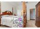 Primary bedroom with four poster bed and floral bedding at 909 Witherbee Way, Little River, SC 29566