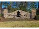Stone monument sign for Cypress Village, with stacked stone and a black silhouette of a cypress tree at 909 Witherbee Way, Little River, SC 29566