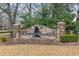 Stone monument sign for Cypress Village, with stacked stone and a black silhouette of a cypress tree at 909 Witherbee Way, Little River, SC 29566