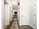 Inviting hallway with hardwood floors, leading to a cozy living room with fireplace at 909 Witherbee Way, Little River, SC 29566