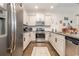 Modern kitchen with stainless steel appliances, white cabinets, and subway tile backsplash at 909 Witherbee Way, Little River, SC 29566