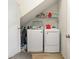 Efficient laundry area with modern appliances, a wire shelf, and convenient under-stair storage at 909 Witherbee Way, Little River, SC 29566