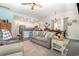 Open-concept living room with a sofa, ceiling fan and a view into the dining and kitchen areas at 909 Witherbee Way, Little River, SC 29566