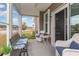 Screened-in patio with a bench and chairs at 909 Witherbee Way, Little River, SC 29566