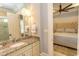 Bathroom showcasing a marble countertop and a view into the bedroom at 9200 Bellasera Circle, Myrtle Beach, SC 29579