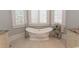 Bright bathroom featuring a luxurious soaking tub with elegant fixtures and three shuttered windows at 9200 Bellasera Circle, Myrtle Beach, SC 29579