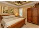 Cozy bedroom with tray ceiling, warm lighting, and wooden furnishings creating a relaxing atmosphere at 9200 Bellasera Circle, Myrtle Beach, SC 29579