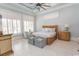 A ceiling fan, large windows and tile floors highlight this comfortable bedroom at 9200 Bellasera Circle, Myrtle Beach, SC 29579