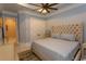 This bedroom boasts a trey ceiling with ceiling fan and large upholstered headboard at 9200 Bellasera Circle, Myrtle Beach, SC 29579