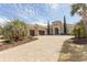 Stately home featuring arched entry, meticulous landscaping, a paver drive, and a two-car garage in a warm, inviting color palette at 9200 Bellasera Circle, Myrtle Beach, SC 29579