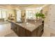 Spacious kitchen island with granite countertops, stainless sink, custom cabinetry, and wine rack at 9200 Bellasera Circle, Myrtle Beach, SC 29579