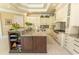 Spacious kitchen with a center island, white cabinets, granite countertops, and stainless steel appliances at 9200 Bellasera Circle, Myrtle Beach, SC 29579