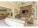 Inviting living room showcasing stone fireplace and open layout with seamless flow to kitchen at 9200 Bellasera Circle, Myrtle Beach, SC 29579