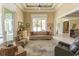 Open-concept living room featuring tray ceilings and access to outdoor spaces at 9200 Bellasera Circle, Myrtle Beach, SC 29579