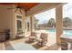 Inviting outdoor living area with a built-in grill, comfortable seating, and a view of the pool and patio at 9200 Bellasera Circle, Myrtle Beach, SC 29579