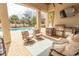Inviting outdoor living area with a built-in grill, comfortable seating, ceiling fan and a view of the pool at 9200 Bellasera Circle, Myrtle Beach, SC 29579