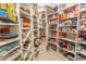 Walk-in pantry with custom shelving offering ample storage space for kitchen essentials at 9200 Bellasera Circle, Myrtle Beach, SC 29579