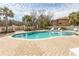 Beautiful kidney-shaped pool with a paved deck, spa, and lounge chairs surrounded by tropical landscaping at 9200 Bellasera Circle, Myrtle Beach, SC 29579