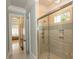 Contemporary shower with glass door, tiled walls, and multiple shower heads in neutral bathroom at 9200 Bellasera Circle, Myrtle Beach, SC 29579