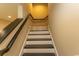 Staircase with black treads and white risers is showcased in this listing photograph at 9200 Bellasera Circle, Myrtle Beach, SC 29579