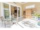Light-filled sunroom with tile flooring and views of the backyard and adjacent living spaces at 9200 Bellasera Circle, Myrtle Beach, SC 29579