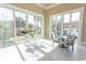 Bright sunroom with large windows providing natural light and views of the backyard and pool at 9200 Bellasera Circle, Myrtle Beach, SC 29579