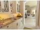 A butler's pantry features granite counters, display cabinets, stylish hardware, and a pass-through to the living area at 9200 Bellasera Circle, Myrtle Beach, SC 29579