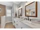 Bright bathroom featuring a double vanity with granite countertop and two framed mirrors at 931 Henry James Dr., Myrtle Beach, SC 29579