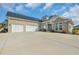 Lovely brick home with three garage doors and landscaped front yard at 931 Henry James Dr., Myrtle Beach, SC 29579