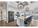Bright kitchen with stainless steel appliances, a large island with bar seating and modern light fixtures at 931 Henry James Dr., Myrtle Beach, SC 29579