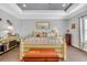 This bedroom has decorative tray ceilings, wood flooring, and comfortable decor at 931 Henry James Dr., Myrtle Beach, SC 29579