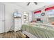 Bright bedroom featuring a dresser and TV with ensuite bathroom access at 9750 Leyland Dr. # 2, Myrtle Beach, SC 29572