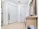 Bright entryway with neutral tile flooring, a charming console table, and a white front door at 9750 Leyland Dr. # 2, Myrtle Beach, SC 29572