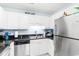 Galley-style kitchen featuring stainless steel appliances, dark stone countertops, and white cabinets at 9750 Leyland Dr. # 2, Myrtle Beach, SC 29572