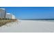 Beautiful beach view featuring white sand and resort buildings with a clear, blue sky background at 9820 Queensway Blvd. # 109, Myrtle Beach, SC 29572