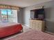 Bright bedroom with two beds and a view of the ocean, complemented by a dresser and soft, natural lighting at 9820 Queensway Blvd. # 109, Myrtle Beach, SC 29572