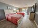 Comfortable bedroom featuring two beds with coral comforters, a dresser, and balcony access for natural light at 9820 Queensway Blvd. # 109, Myrtle Beach, SC 29572