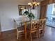 Cozy dining area with a glass-top table and chairs adjacent to the sliding glass doors at 9820 Queensway Blvd. # 109, Myrtle Beach, SC 29572