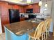 Well-equipped kitchen with stainless steel appliances, granite countertops, a tiled backsplash, and breakfast bar seating at 9820 Queensway Blvd. # 109, Myrtle Beach, SC 29572