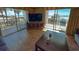 Inviting living room with a large TV and access to the ocean view balcony at 9820 Queensway Blvd. # 109, Myrtle Beach, SC 29572