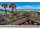 Amazing ocean view from a wood walkway with a pool and palms nearby at 9820 Queensway Blvd. # 109, Myrtle Beach, SC 29572