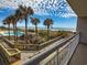 Scenic view from the balcony overlooking the pool, beach, and ocean, with palm trees enhancing the tropical atmosphere at 9820 Queensway Blvd. # 109, Myrtle Beach, SC 29572