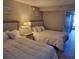 Bright bedroom featuring two cozy beds with white bedding and a nightstand with lamps for a relaxing retreat at 1501 S Ocean Blvd. S # 1041, Myrtle Beach, SC 29577