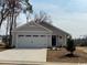 Charming single-story home featuring a two-car garage and well-manicured landscaping at 1011 Oak Meadow Dr., Conway, SC 29526