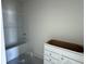 Bathroom features a bathtub with tile surround and a vanity cabinet with drawers ready for customization at 1013 Jase Dr., Longs, SC 29568