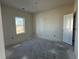 Minimalist bedroom with natural light and a simple design featuring a single window and a closet door at 1013 Jase Dr., Longs, SC 29568