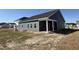 Rear view of the home featuring a covered porch and gray siding at 1013 Jase Dr., Longs, SC 29568