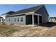 Exterior view of home showing the back porch and gray vinyl siding at 1013 Jase Dr., Longs, SC 29568